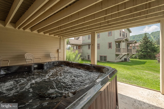 view of terrace with central AC and a hot tub