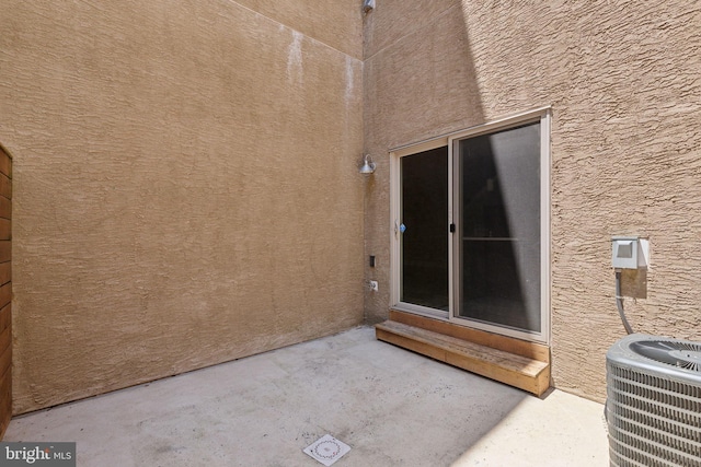 doorway to property with a patio area and central AC