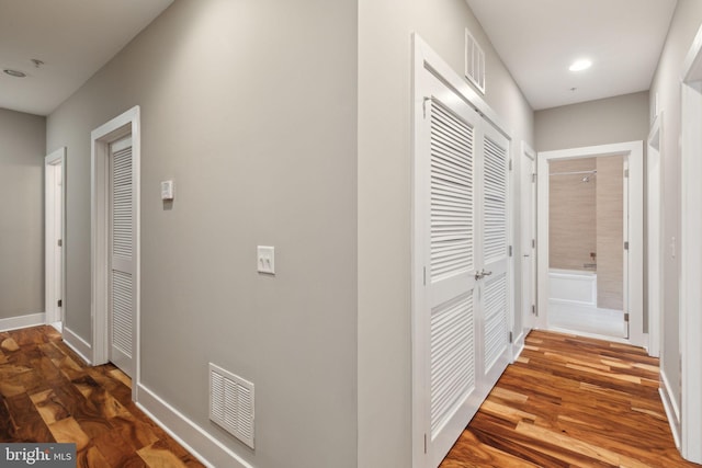 corridor with dark hardwood / wood-style floors