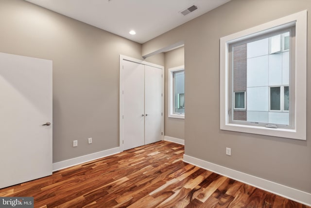 unfurnished bedroom featuring hardwood / wood-style flooring