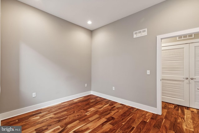 empty room featuring dark wood-type flooring