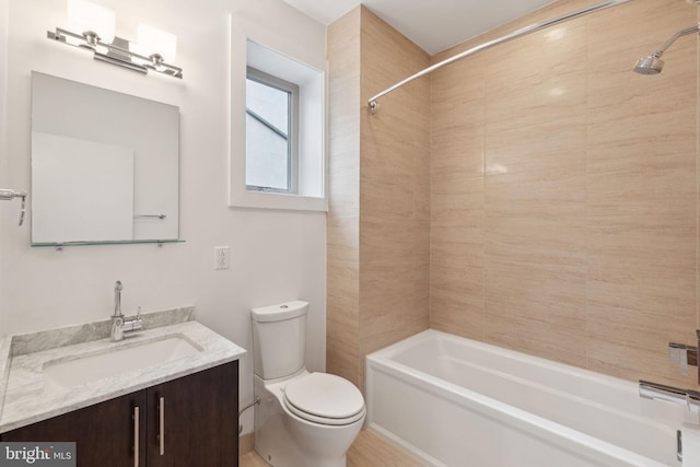 full bathroom featuring vanity, toilet, and tiled shower / bath