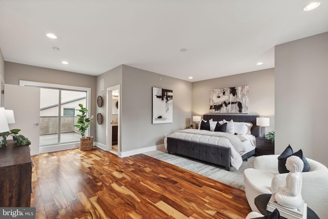 bedroom featuring hardwood / wood-style flooring and ensuite bathroom