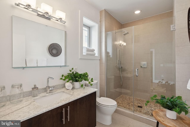 bathroom with toilet, tile patterned flooring, vanity, and walk in shower