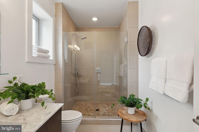 bathroom featuring tile patterned floors, toilet, and walk in shower