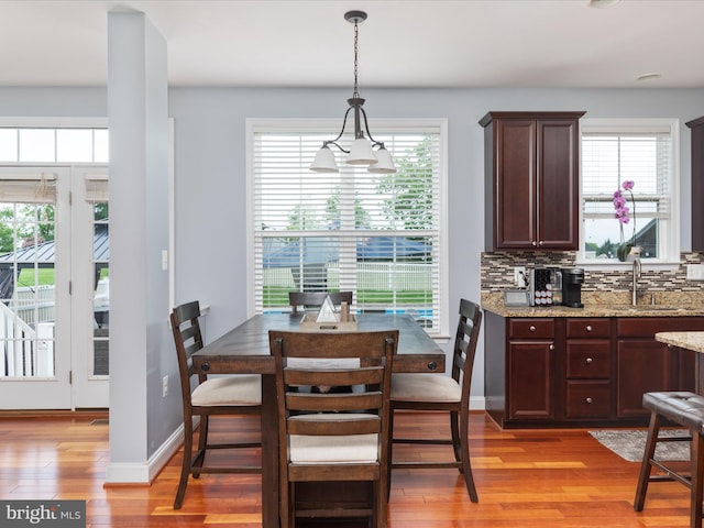 dining space featuring sink and light hardwood / wood-style floors