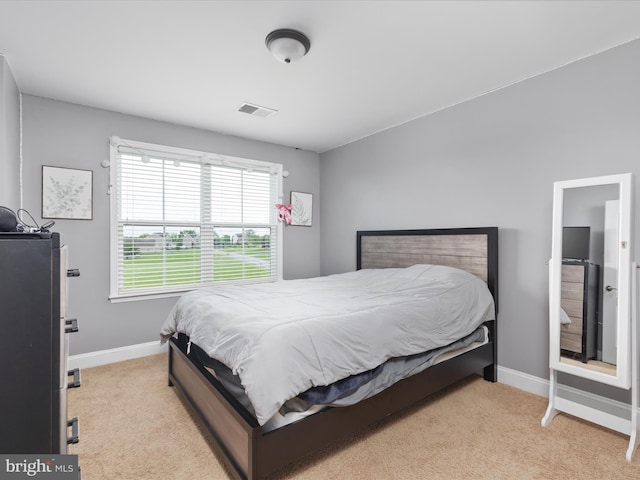 bedroom featuring light carpet