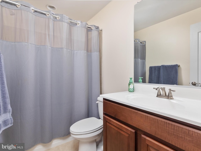 bathroom with tile flooring, oversized vanity, and toilet