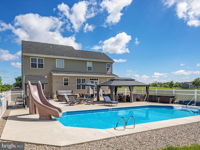 view of pool featuring a water slide and a patio