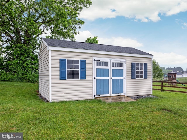 view of shed / structure featuring a lawn