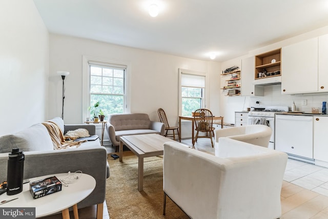 living room featuring plenty of natural light and light tile floors