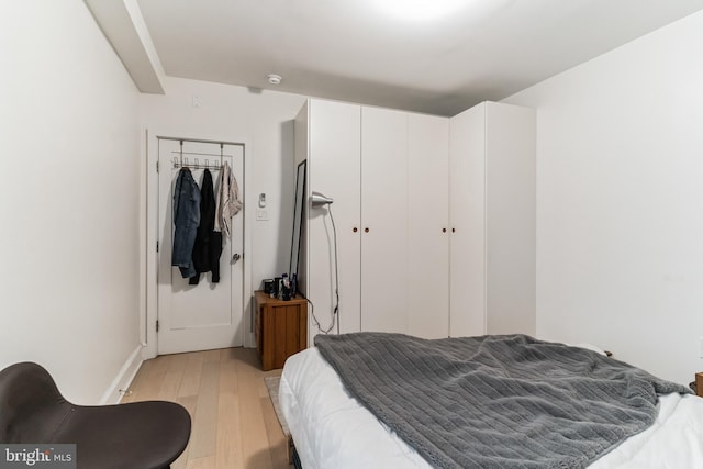 bedroom featuring a closet and light hardwood / wood-style flooring