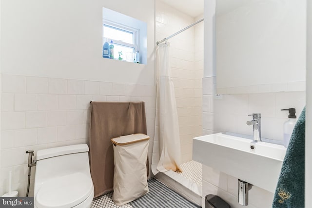 bathroom featuring toilet and tile walls