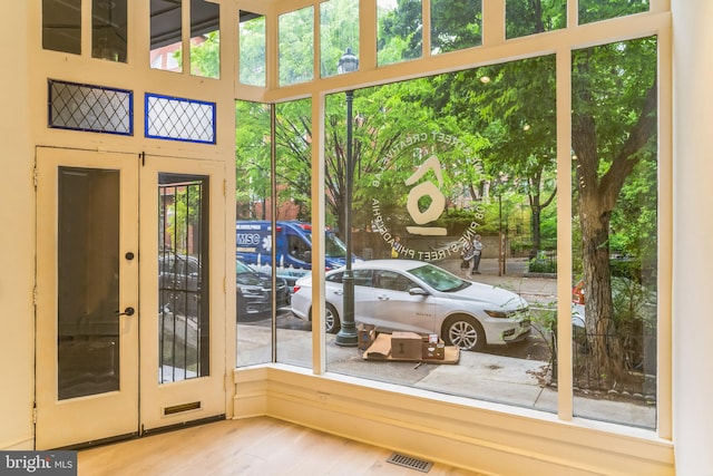 unfurnished sunroom featuring french doors