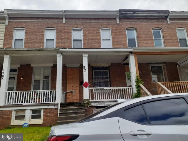 view of property featuring covered porch