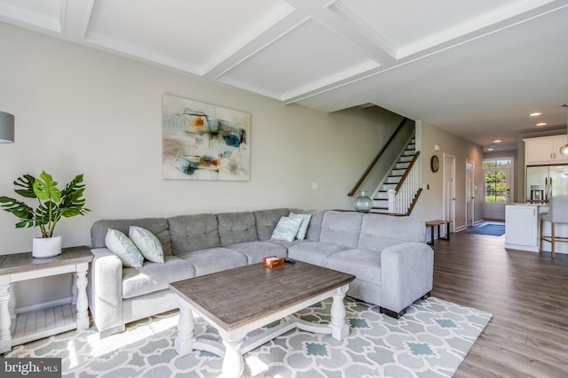 living room featuring beam ceiling, coffered ceiling, and hardwood / wood-style floors