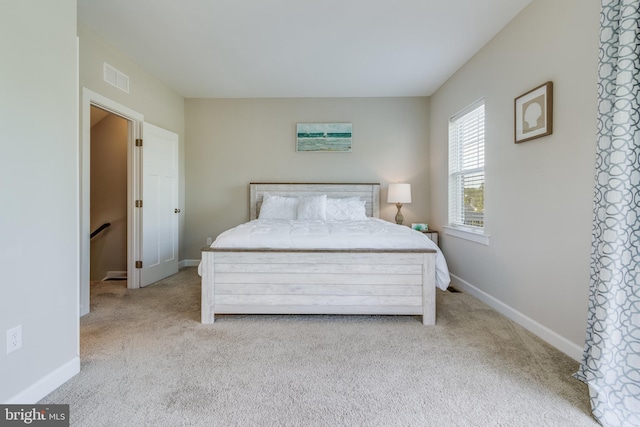 bedroom featuring light colored carpet