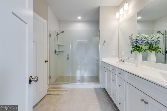 bathroom with tile flooring, an enclosed shower, double sink, and oversized vanity