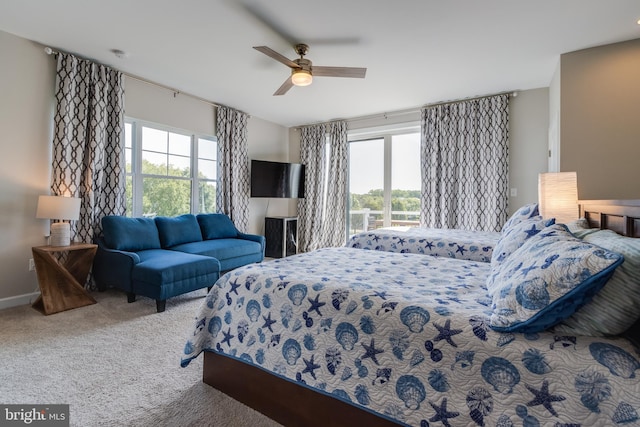 bedroom featuring carpet flooring, ceiling fan, and multiple windows