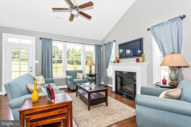 living room featuring a healthy amount of sunlight, ceiling fan, and hardwood / wood-style flooring