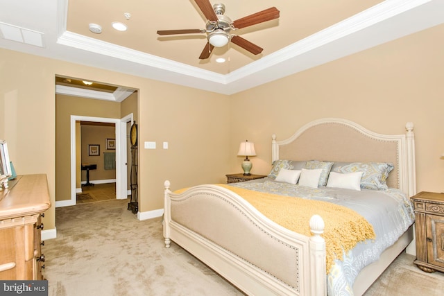 bedroom with ceiling fan, a raised ceiling, light carpet, and ornamental molding