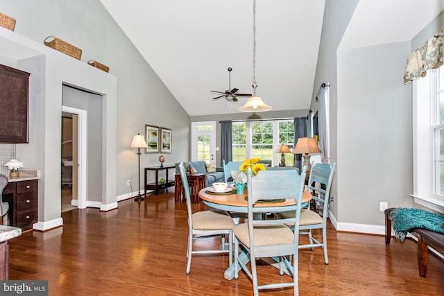 dining area with high vaulted ceiling, ceiling fan, and hardwood / wood-style floors