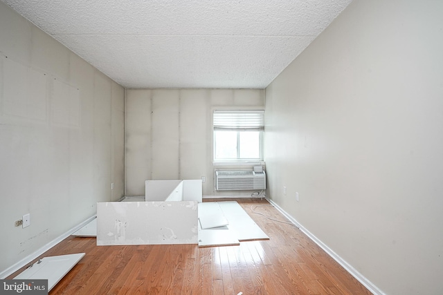 interior space featuring an AC wall unit and light hardwood / wood-style floors