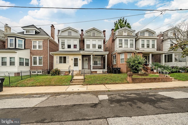 townhome / multi-family property with a porch