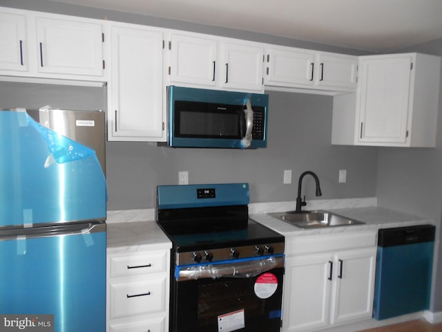 kitchen featuring white cabinets, sink, and appliances with stainless steel finishes