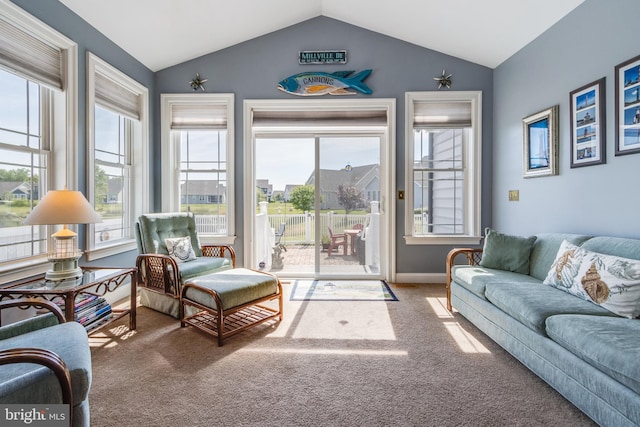 carpeted living room featuring vaulted ceiling