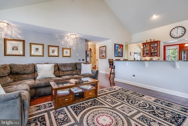 living room with high vaulted ceiling and hardwood / wood-style floors