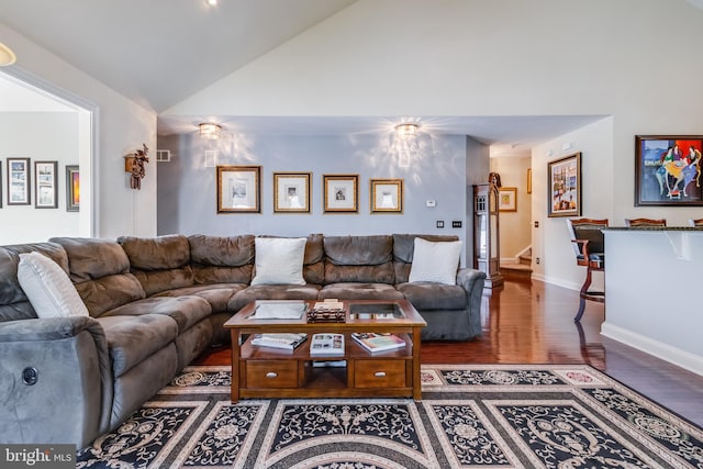 living room with high vaulted ceiling and hardwood / wood-style flooring