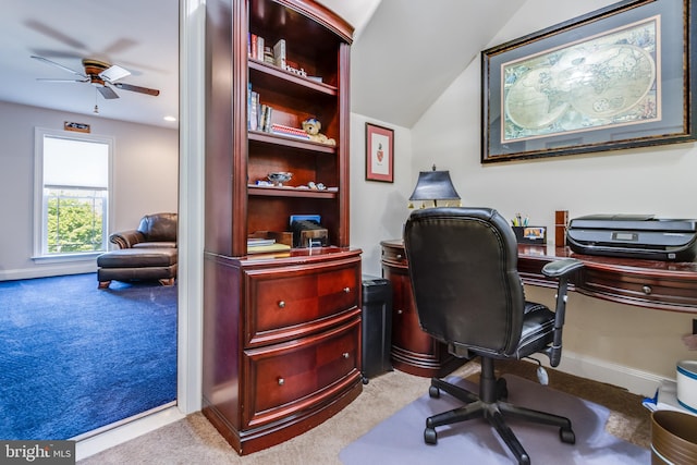 carpeted home office with ceiling fan and lofted ceiling