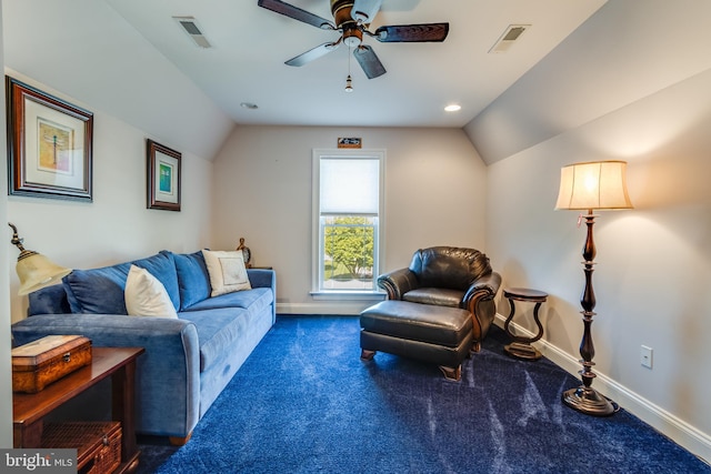 carpeted living room with ceiling fan and vaulted ceiling