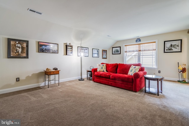 carpeted living room featuring vaulted ceiling