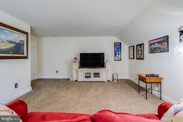 carpeted living room featuring lofted ceiling