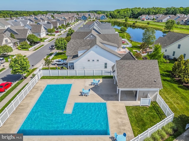 view of pool with a patio area and a water view