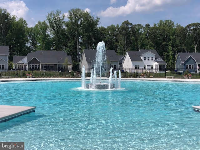 view of swimming pool featuring pool water feature