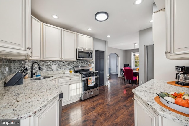 kitchen with dark hardwood / wood-style floors, white cabinetry, and appliances with stainless steel finishes