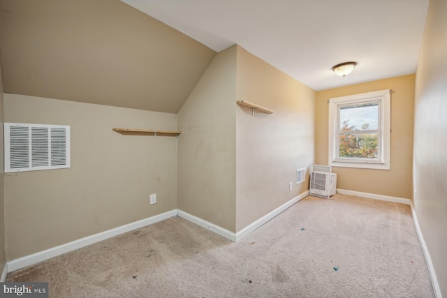 additional living space with vaulted ceiling and light colored carpet