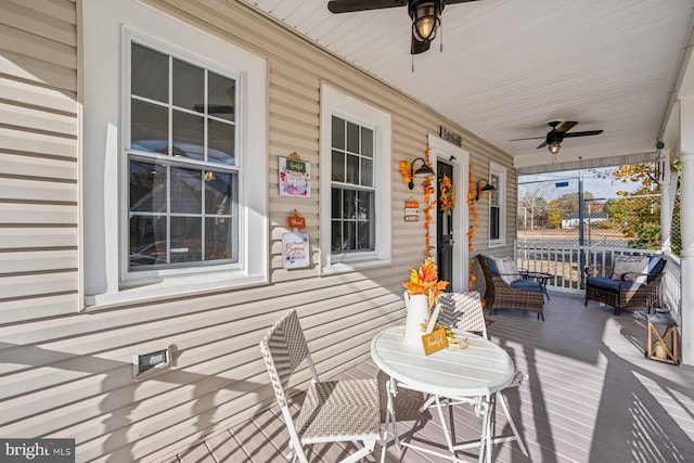 wooden deck with covered porch and ceiling fan