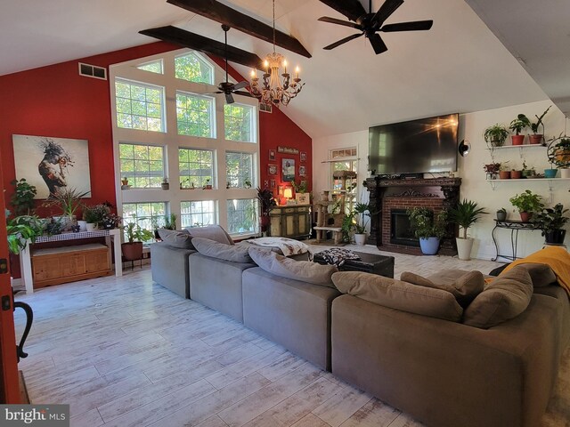 living room with beam ceiling, high vaulted ceiling, a notable chandelier, a fireplace, and light hardwood / wood-style floors