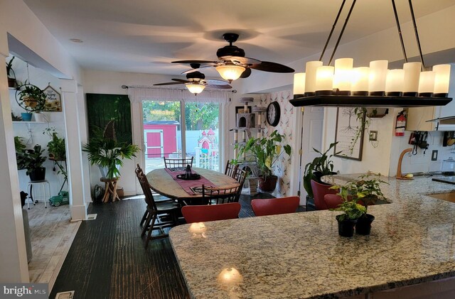 dining area with ceiling fan and dark hardwood / wood-style flooring