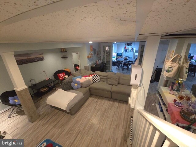 living room with hardwood / wood-style flooring and beam ceiling