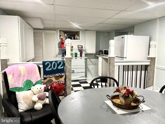 dining room featuring a drop ceiling