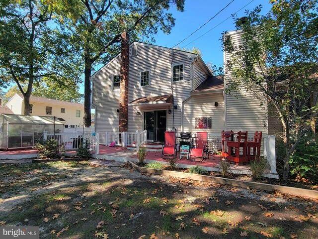 back of property featuring an outbuilding and a patio