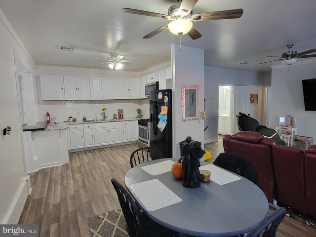 dining space featuring sink and light hardwood / wood-style flooring