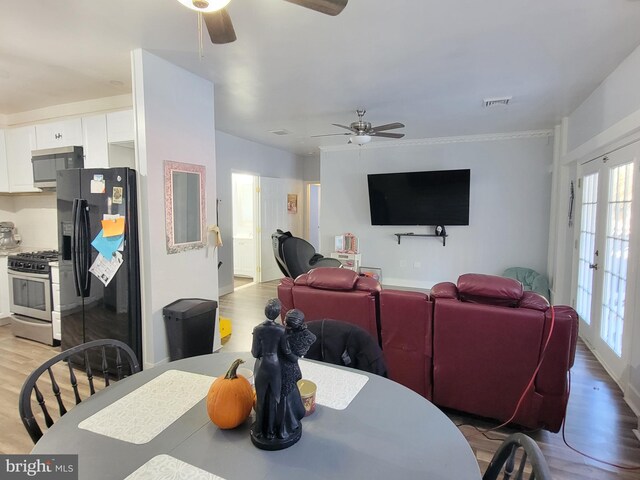 dining area featuring ceiling fan, french doors, and light hardwood / wood-style flooring