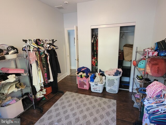 bedroom featuring dark hardwood / wood-style floors and a closet