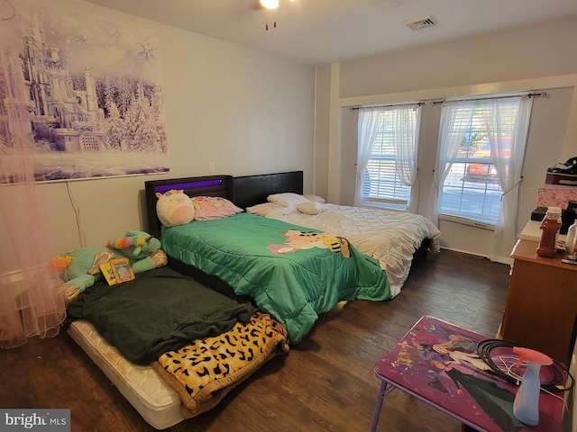 bedroom with dark wood-type flooring